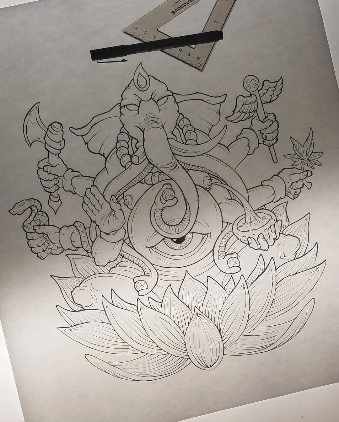 Line drawing of an elephant-headed deity with multiple arms, holding a sword, a spear, a plant, and a staff, with a large lotus flower at the bottom.