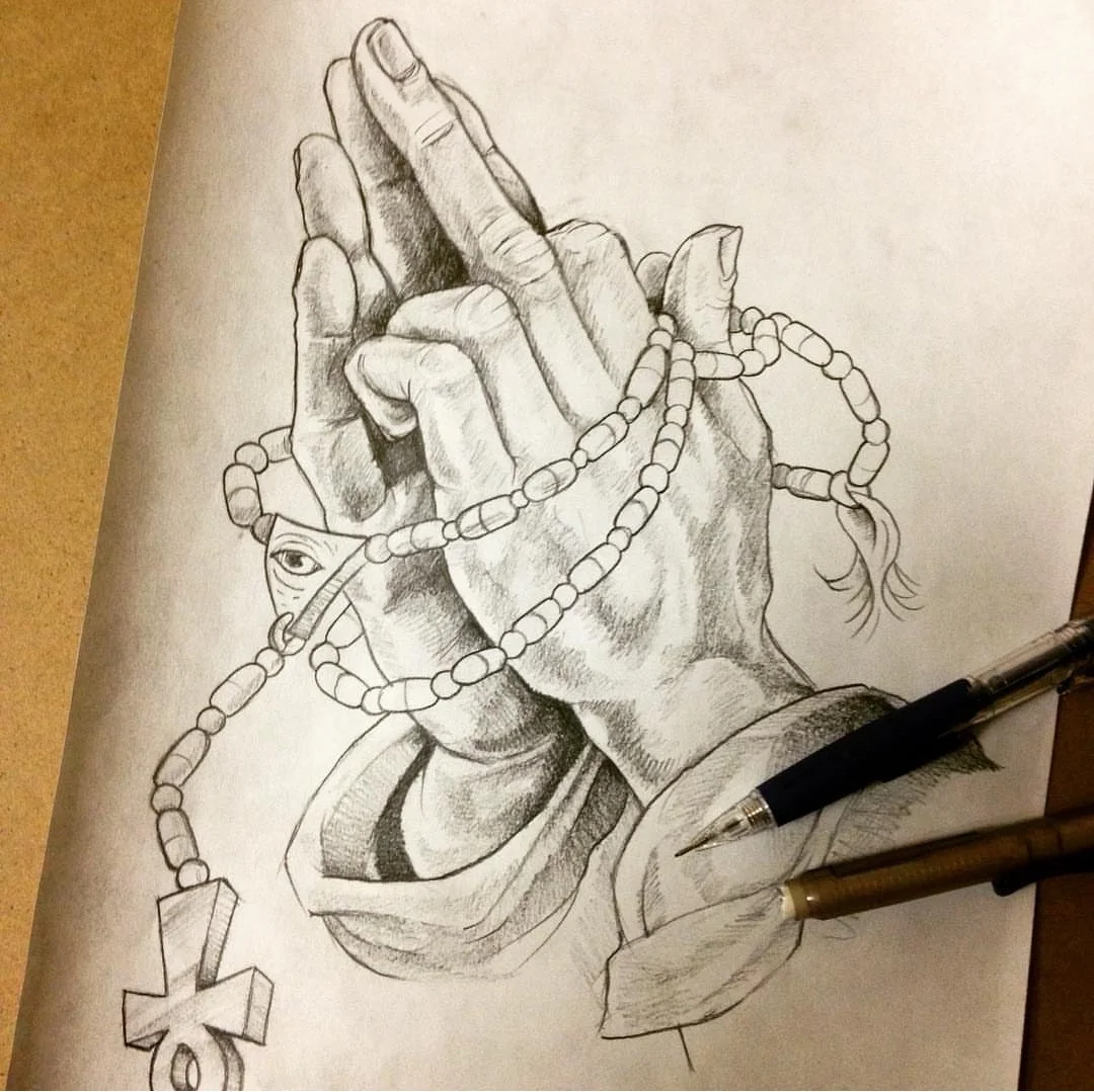 A detailed pencil sketch of a hand holding a pill-beaded rosary, with an ankh at the end. The hand is wearing a sleeve, and a small eye is drawn on the rosary