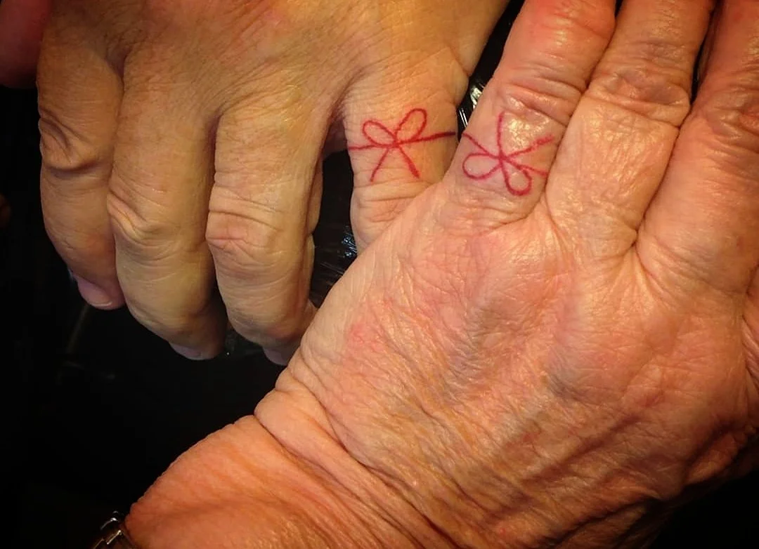 House of ink Tattoo Description: Hand Tattoo, Red String wrapped around pinky finger, couples tattoo