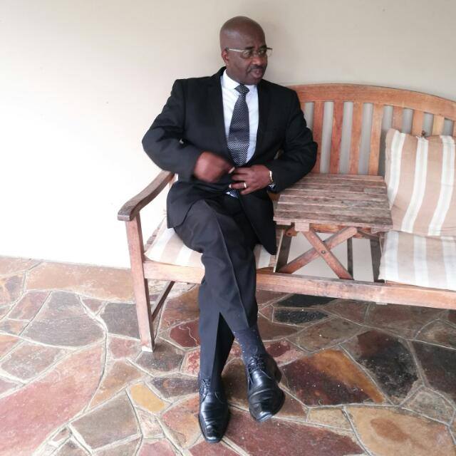 Mthunywa Ngonzo the business owner of Amatola Air Conditioning sitting on a bench.