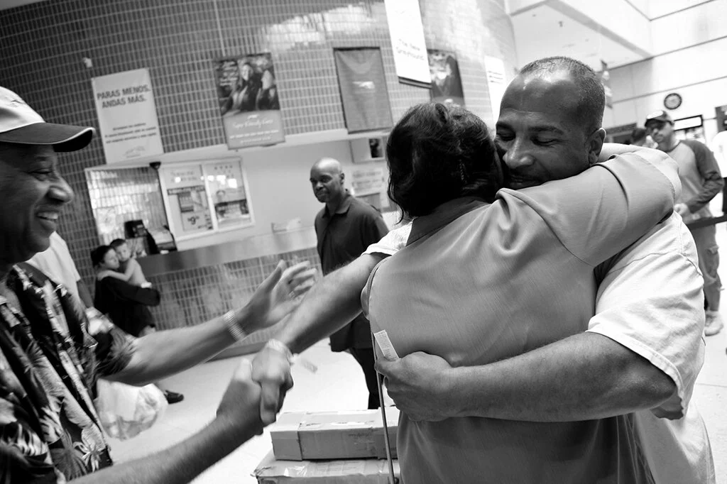  Lloyd Byron Martell, 41, hugs his mother Donna Martin, 60, and shakes hands with German Martin, 76, both of Dearborn, after being released on parole from Southern Michigan Correctional Facility in Jackson, Mich at the Greyhound Bus Depot in Detroit,