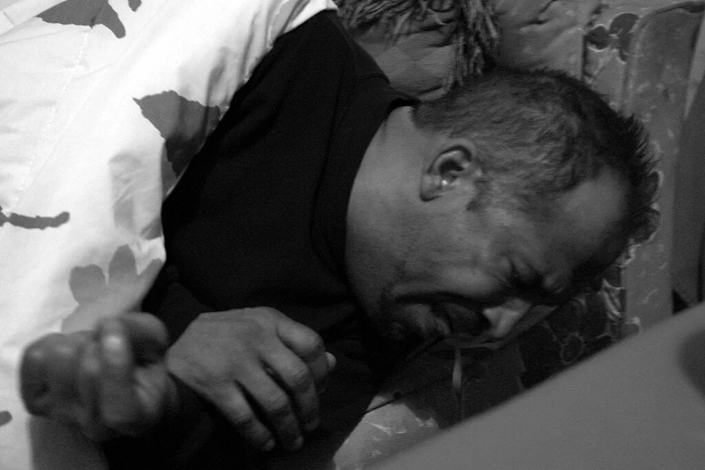  Lloyd Byron Martell has a violent coughing fit spitting up blood as he lays on the couch in the living room at the Jesus House on Sunday, Dec. 3, 2006. The Jesus House is a discipleship program through the church Peacemakers International. 