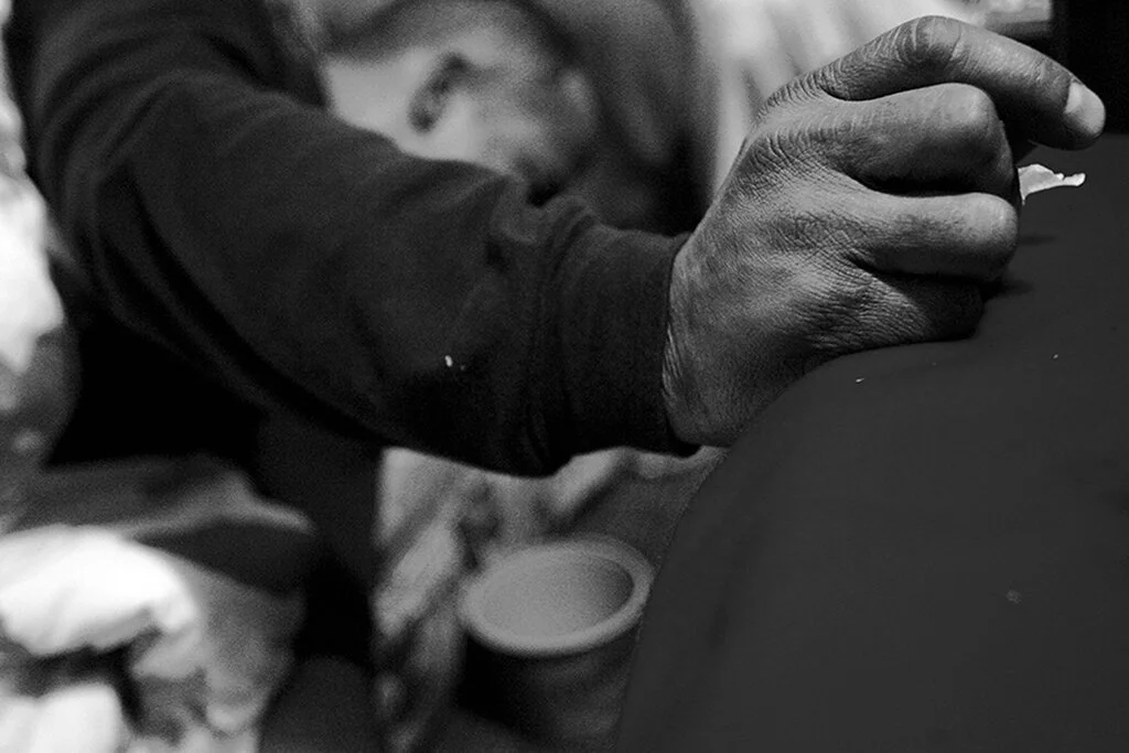 Lloyd Byron Martell has a violent coughing fit spitting up blood as he lays on the couch in the living room at the Jesus House on Sunday, Dec. 3, 2006. The Jesus House is a discipleship program through the church Peacemakers International. 
