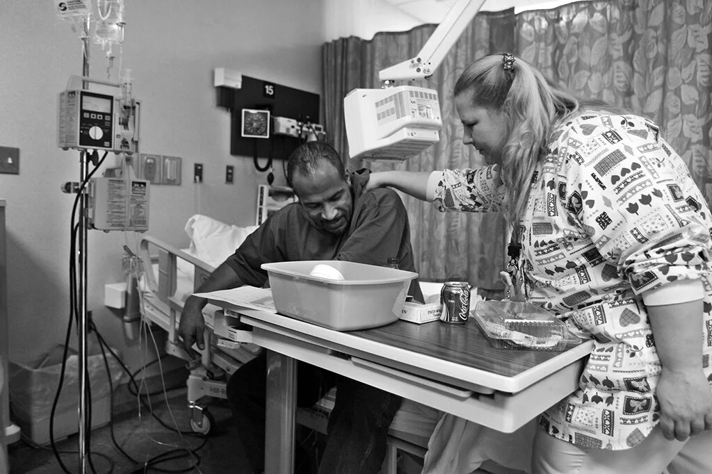  A nurse rubs Lloyd Byron Martell’s shoulder, showing a small act of kindness giving Martell respite from his chemo treatment at the Cancer Treatment Center at Oakwood Hospital  Medical Center, in Dearborn, Mich., Wednesday, Nov. 8, 2006.  