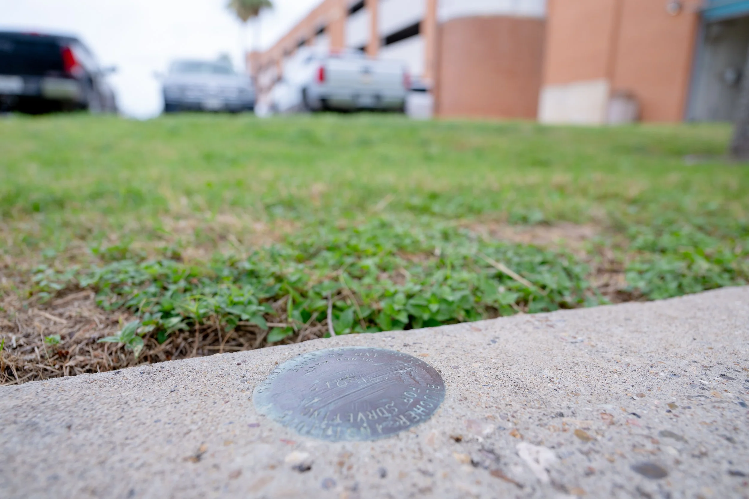 A monument in a sidewalk.