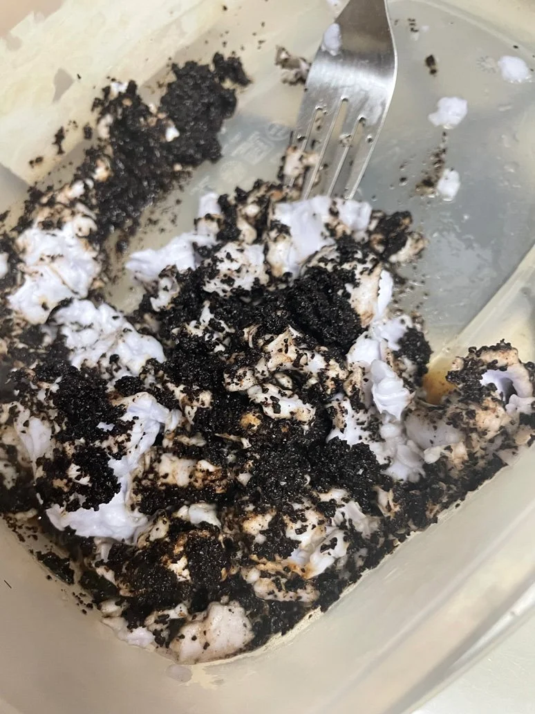 Mixing cooled, freshly brewed coffee grounds with mushed paper