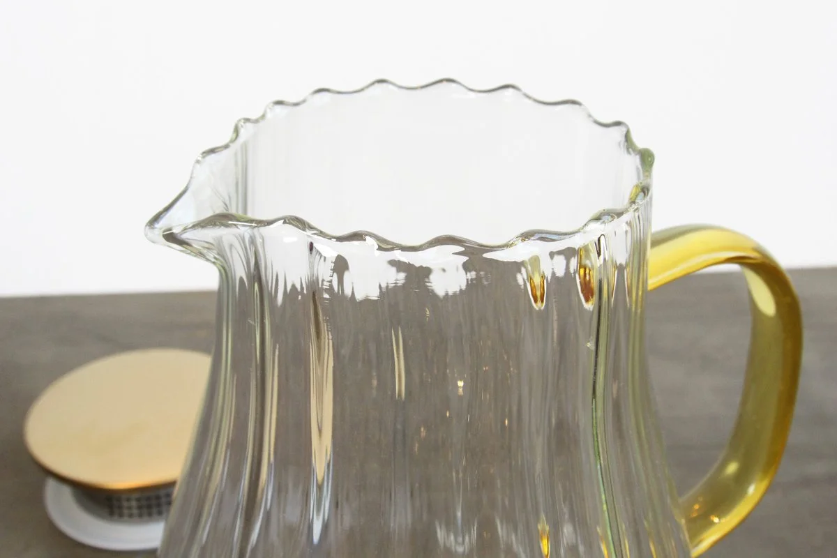 Close-up of the lip of a fluted glass tea pitcher