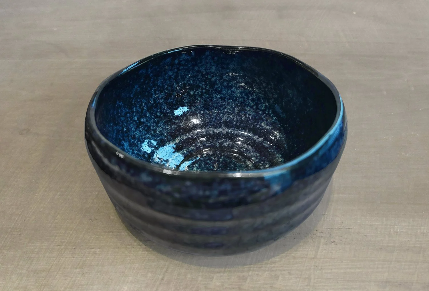 top view of a midnight blue glaze matcha bowl