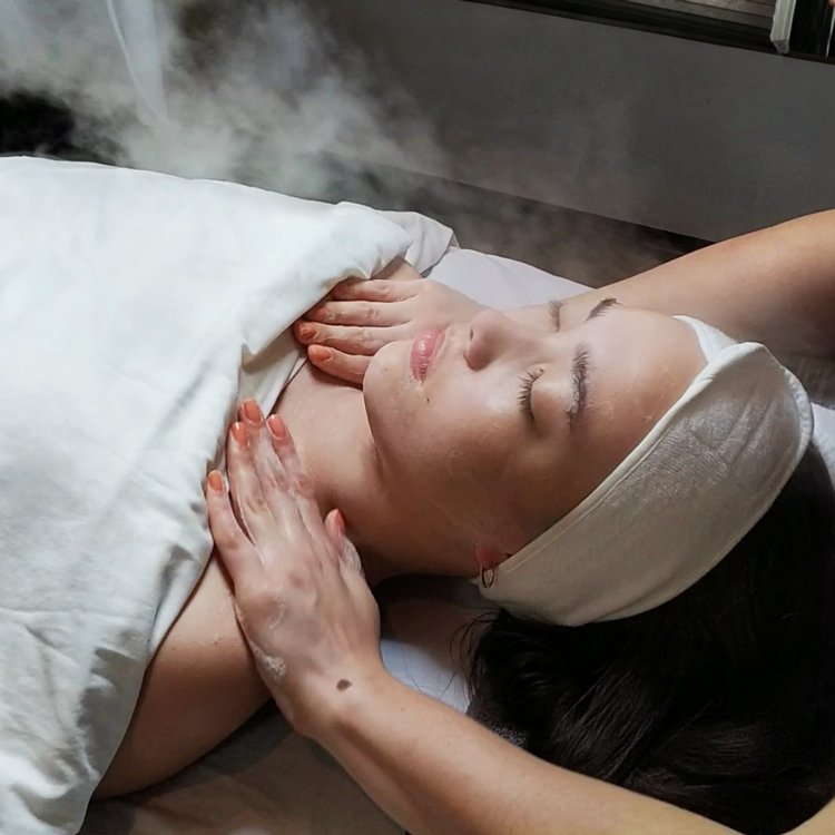 Woman receiving a décolleté massage and facial steaming during a facial treatment