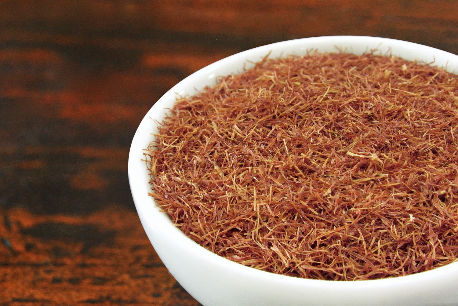Close up of loose cornsilk tea in a white tea bowl