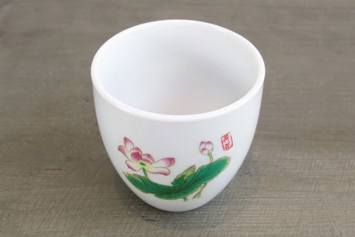 top view of white Chinese teacup with lotus flower pattern