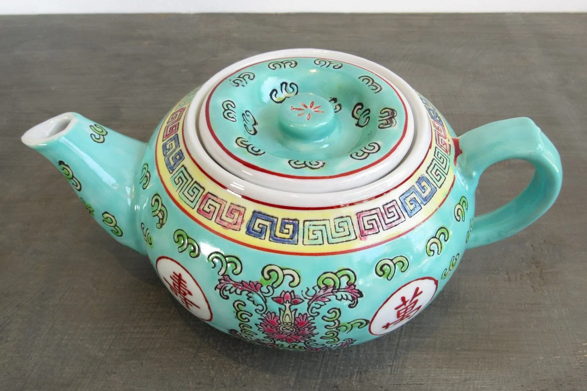 Light turquoise teapot with hand-painted red Chinese characters and multicolor botanical patterns