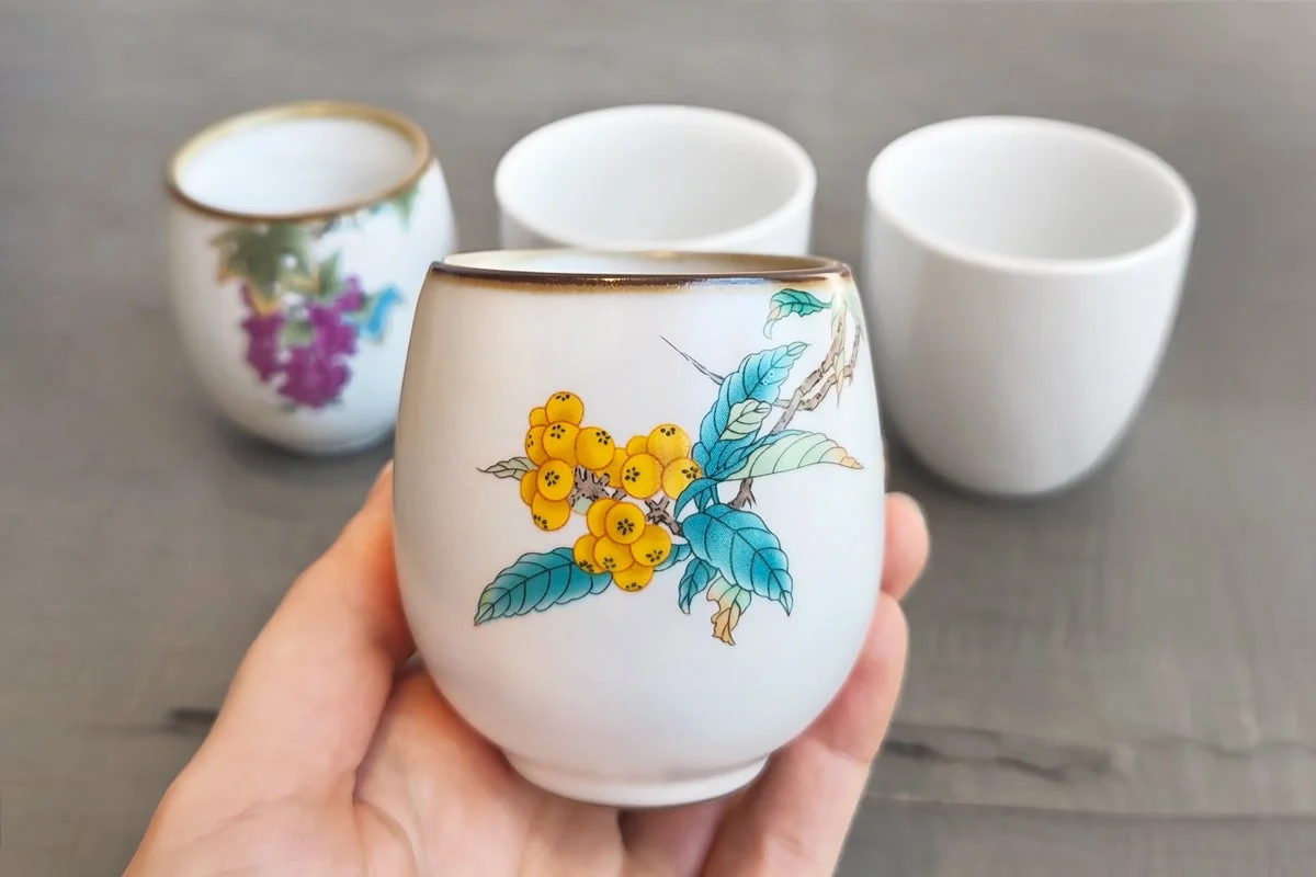 Chinese Crackle Glaze cup with loquat branch pattern in hand