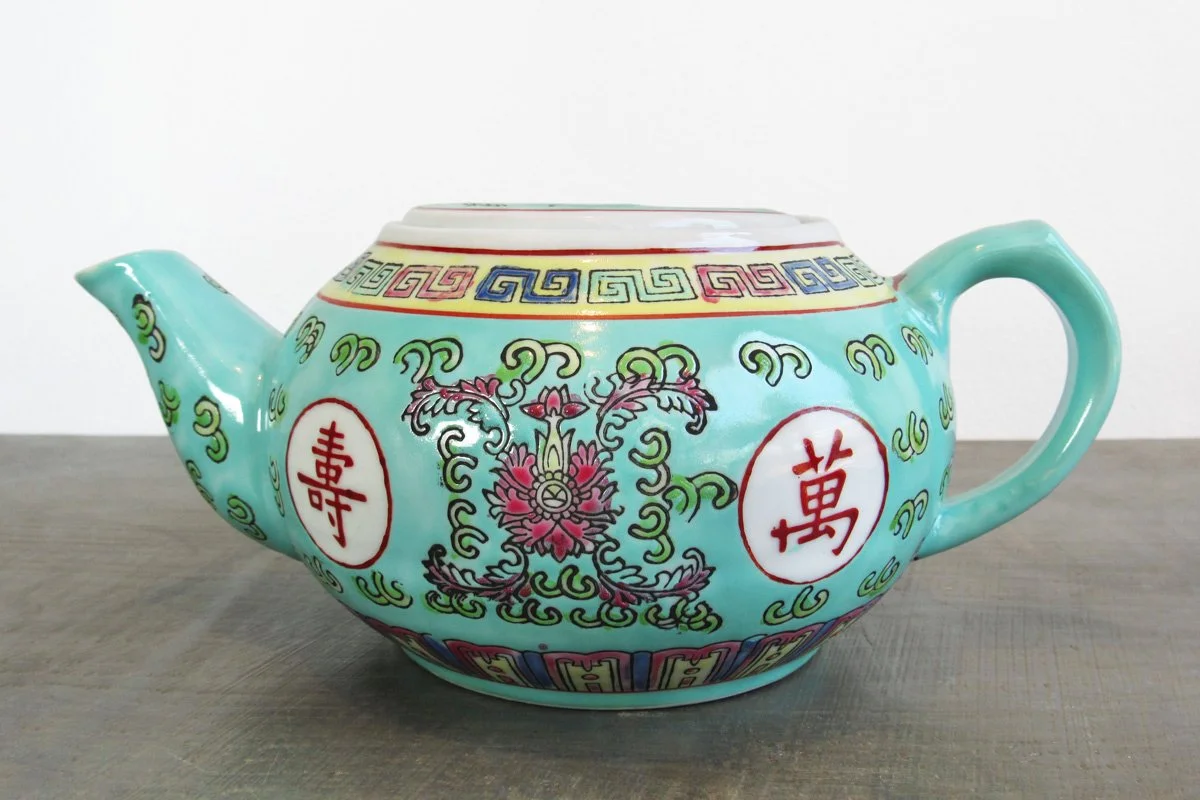 Light turquoise teapot with hand-painted red Chinese characters and multicolor botanical patterns