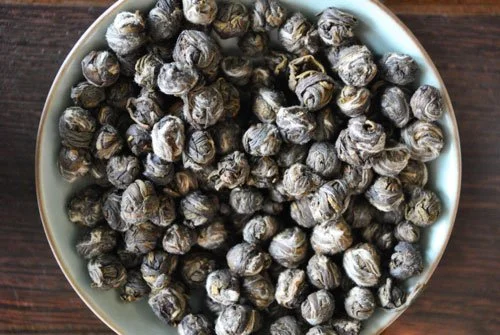  hand rolled jasmine green tea leaves in tea bowl