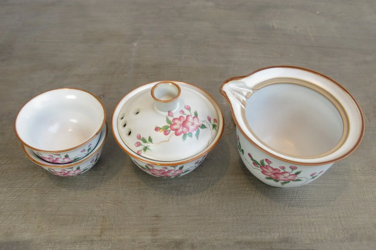 Pink blossom gaiwan set with two teacups and a tea pitcher called a gong dao bei