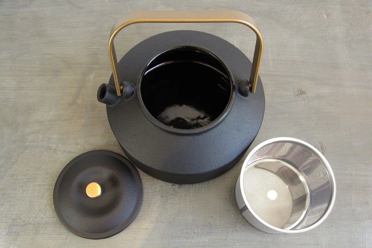 Top-down view of a black cast iron teapot showing the black enameled interior