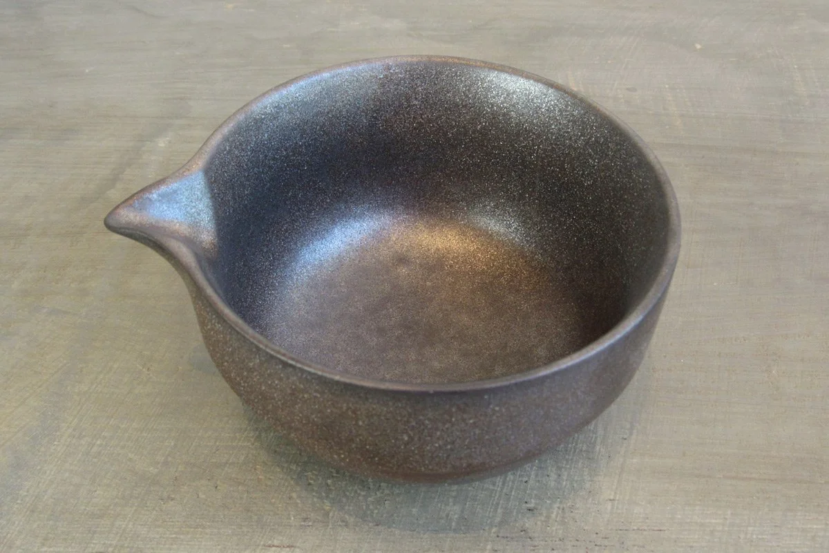 Top view of spouted matcha bowl with a dark textured glaze with a metallic shimmer