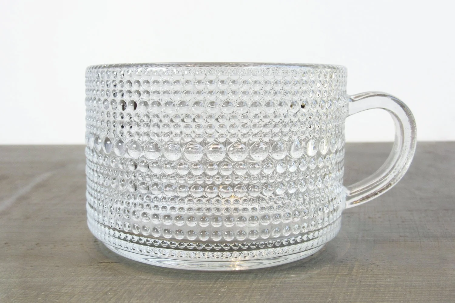 Closeup of a 12 ounce glass tea mug with an embossed hobnail texture