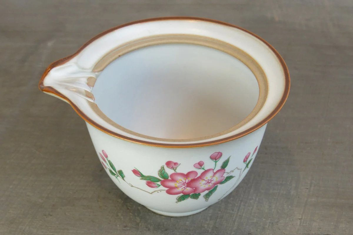 Top-down view of a tea pitcher (gong dao bei) decorated with pink blossoms
