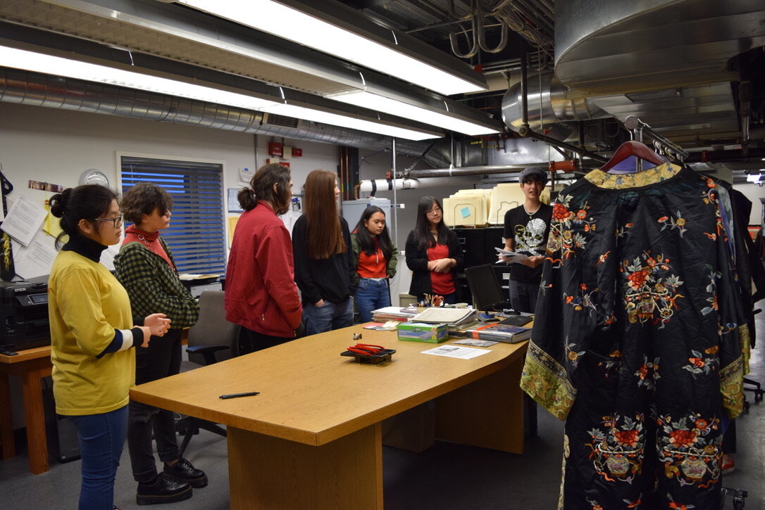  Students study and interact with garments from the Wing Luke Collection.  