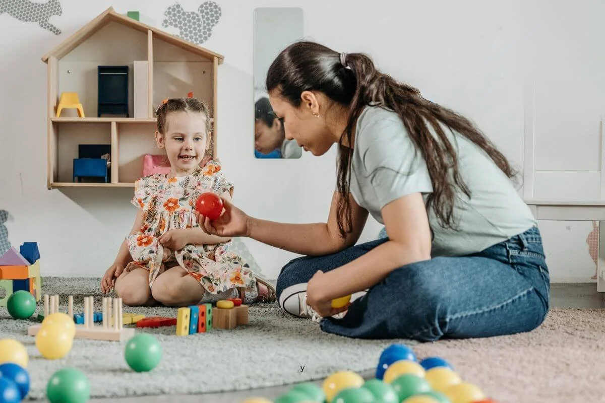 Girl playing with a ball during a play based autism evaluation in NJ