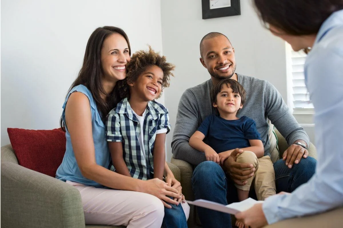 Family with two children smiling during a neurodiversity affirming ADHD and Autism evaluation consultation at True Reflections Mental Health Services in Middlesex NJ
