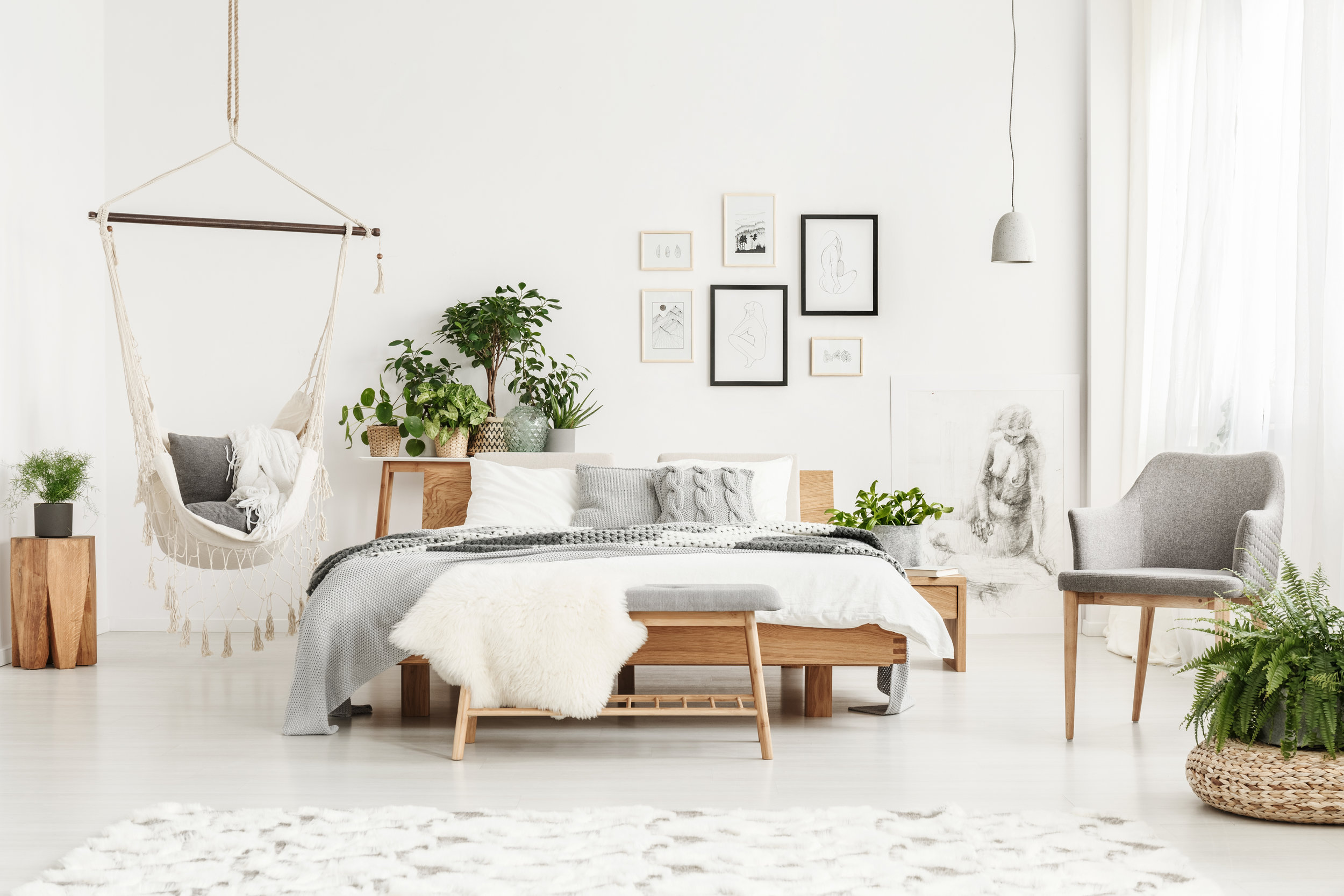 white bedroom with macrame hammock
