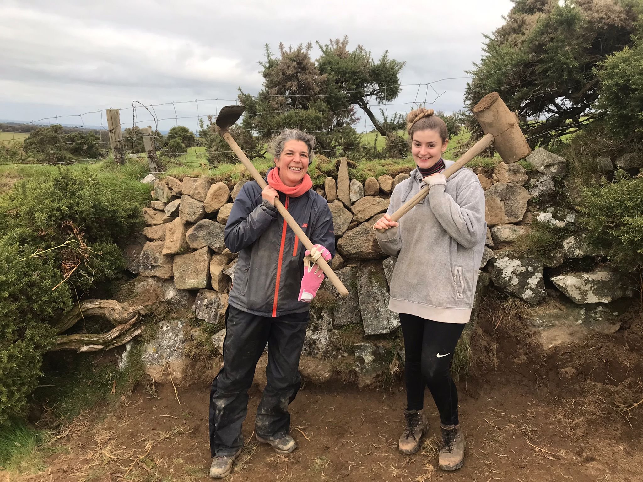 L-R Tamsin Thomas, the Dartmoor project officer with volunteer stone wall repairer Rowan Jewell..jpg