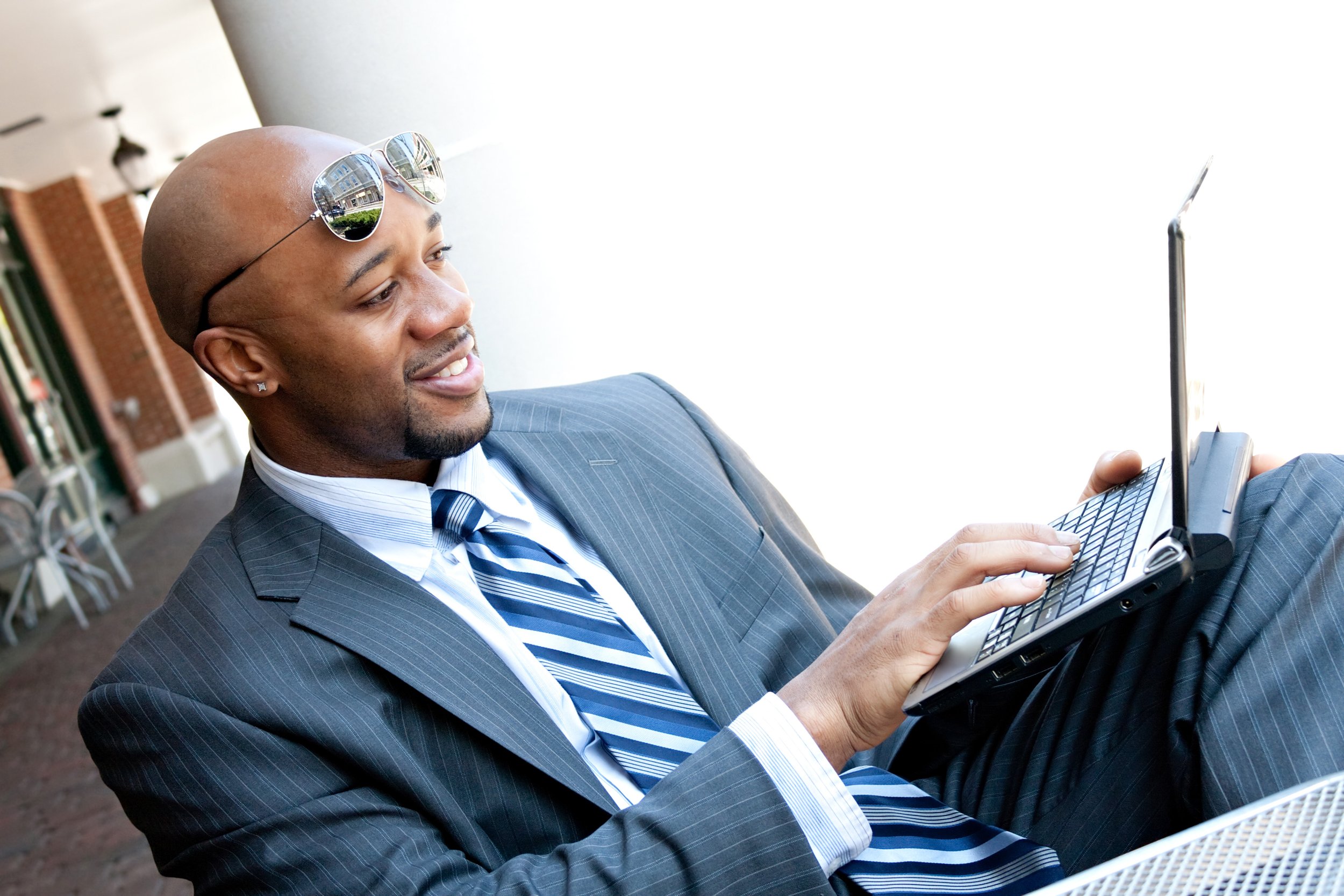 an-african-american-business-man-in-his-early-30s-using-his-laptop-or-netbook-computer-outdoors-with-copy-space-for-your-text_BKu-2w0Sj.jpg