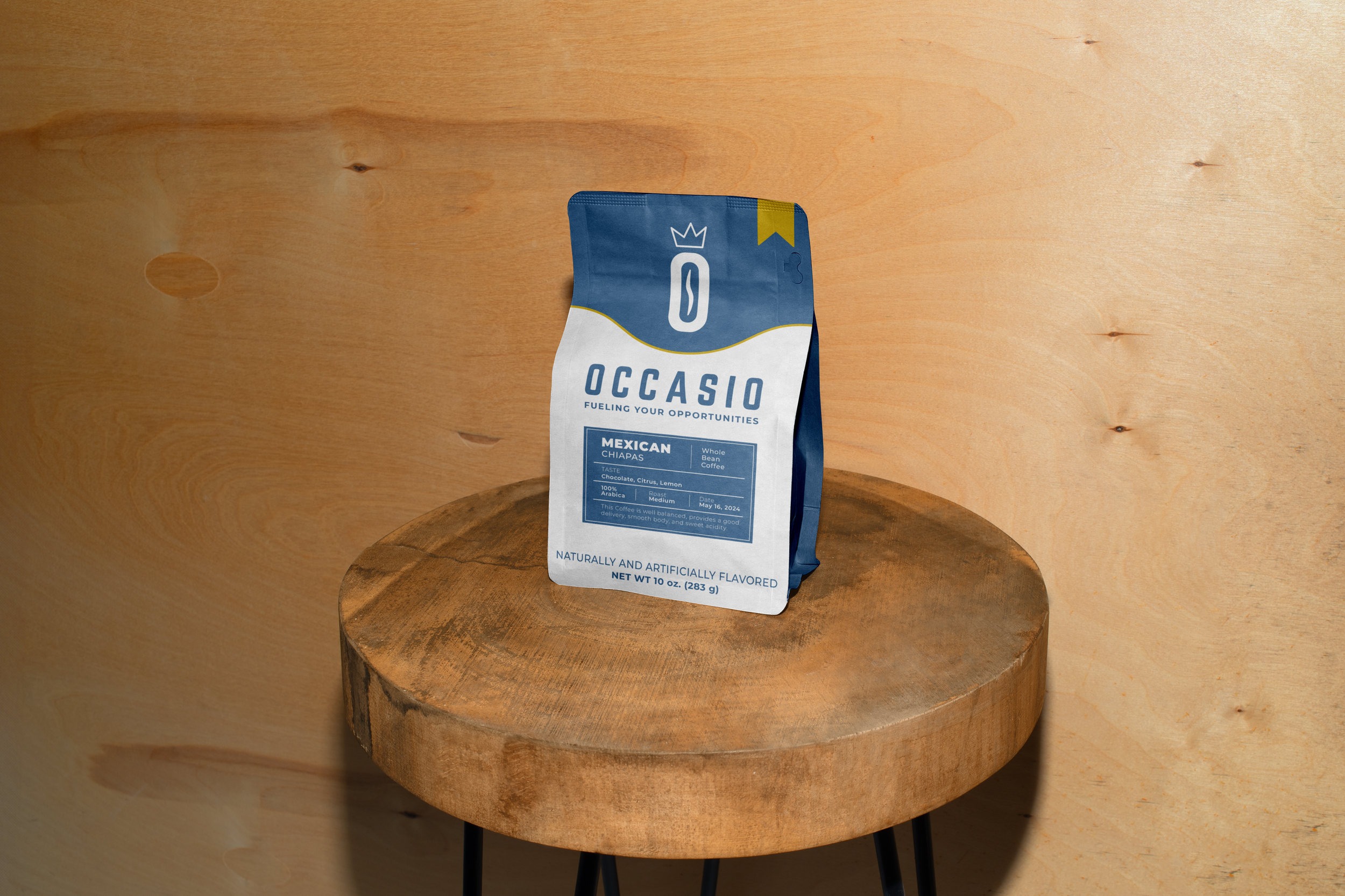 A package of Occasio Mexican coffee on a round wooden table against a light-colored wall background.
