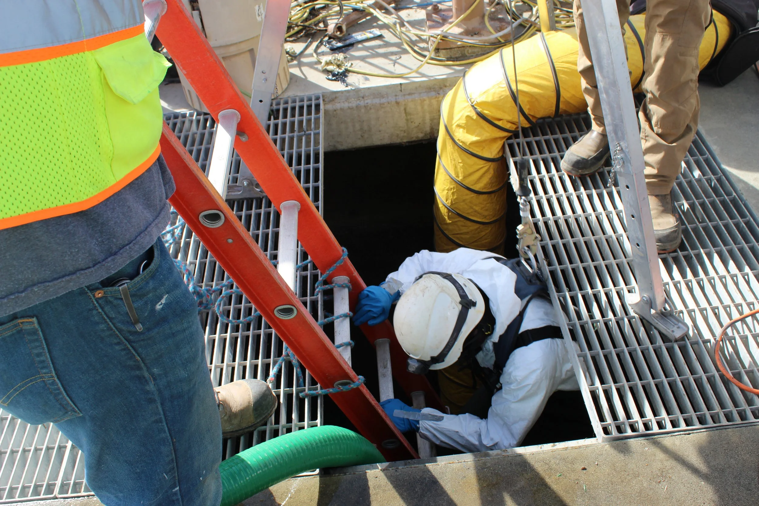 An image of someone inspecting pipes