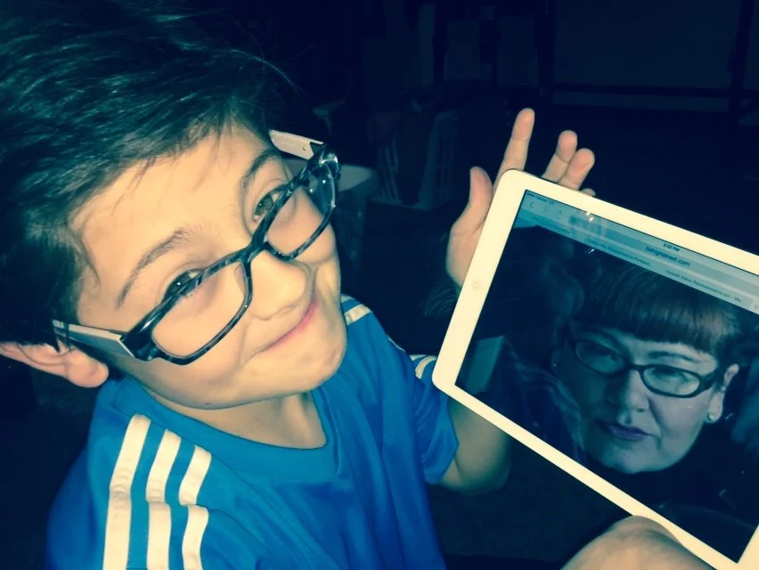  This is a photo of Hayden Lefur, Leah Spurrier's nephew - wearing glasses to look like Leah Spurrier - while holding up a digital image of leah Spurrier. Hayden lives in Portland Oregon and now drives a hot car. Leah Spurrier still wears glasses and