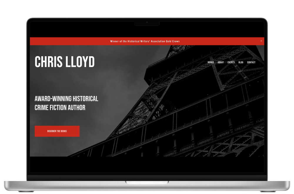 Laptop screen displaying an author's website with a black and white image of the Eiffel Tower. The screen features text about an award-winning historical crime fiction author, with navigation links at the top.