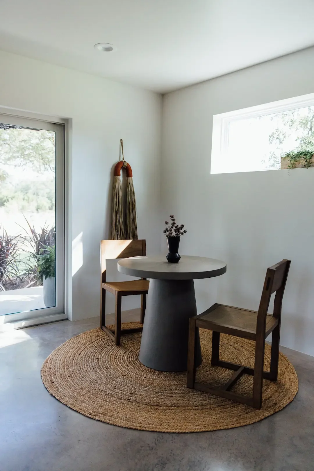 nowhere-hammock-lodge-round-dining-table-wooden-chairs.webp