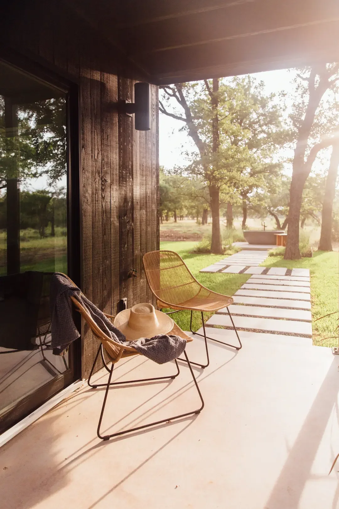 nowhere-hammock-lodge-covered-patio-chairs-stone-path.webp