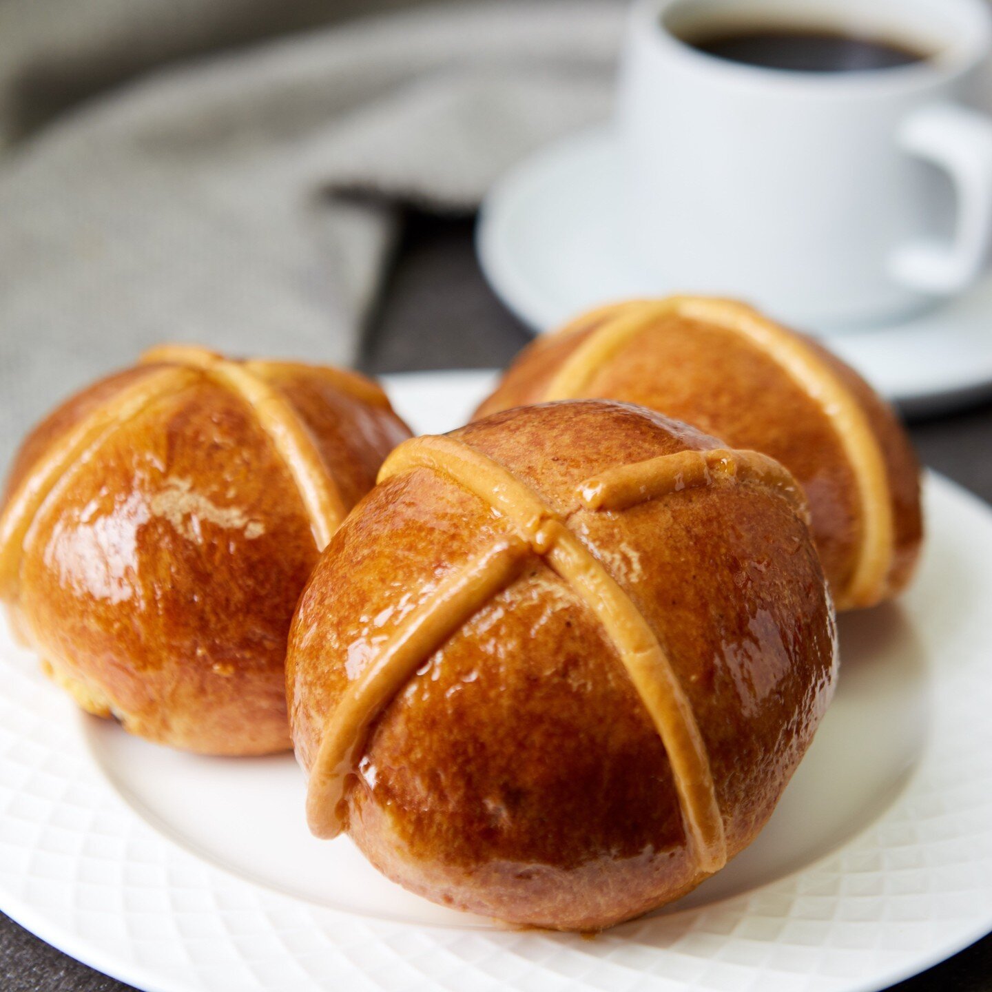 Nothing says Easter morning like freshly baked Hot Cross Buns smeared with butter paired with a cup of tea. We brighten up these classic brioche rolls with currants, lemon zest, and warm spices. Order now on our website at nrbakery.com/easter!