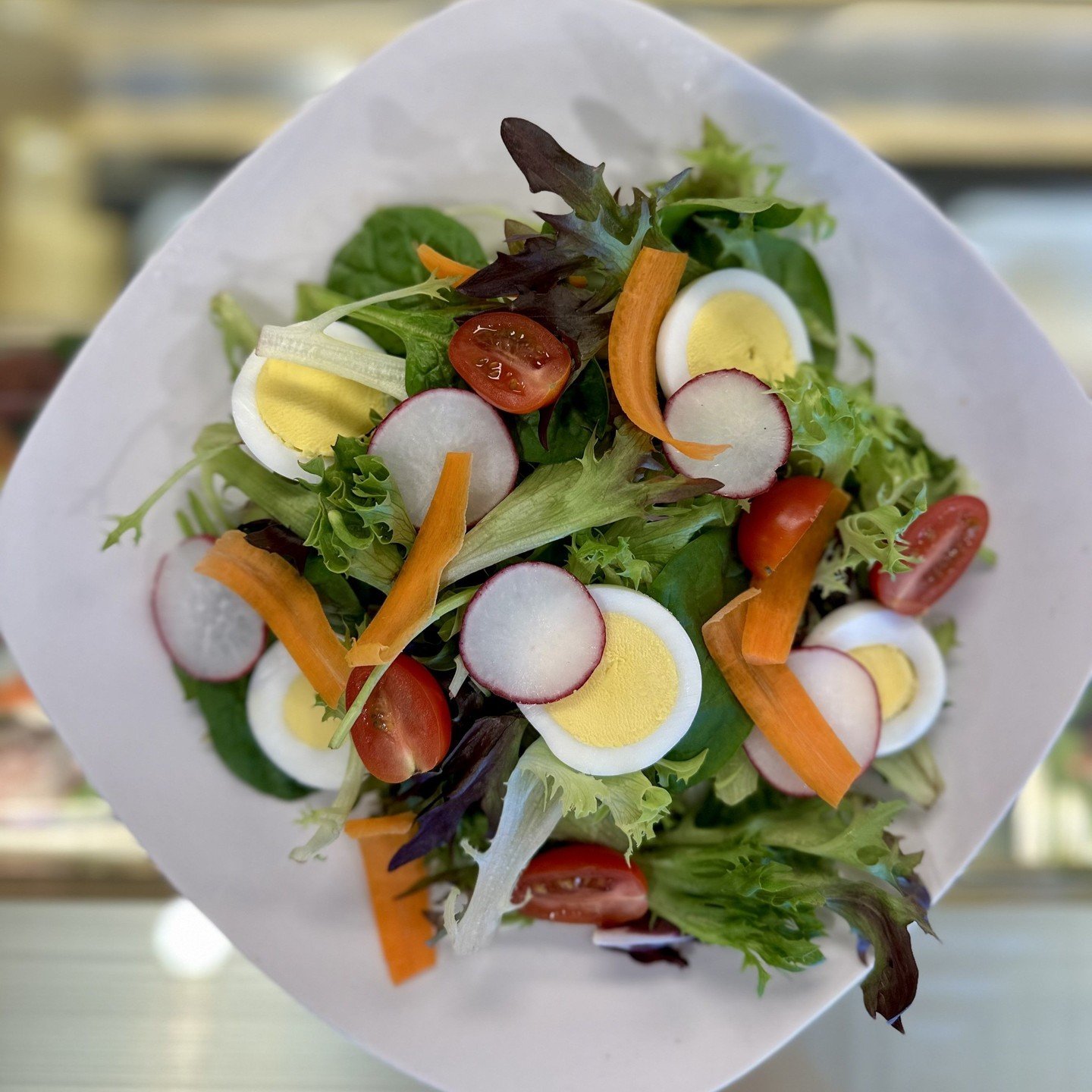 Welcome the new Farmhouse Salad! We pair hard boiled egg, carrot, radish, and tomato with a sherry - tarragon vinaigrette for a delicious, light and refreshing meal. The best part? It goes perfectly with a slice of our quiche!