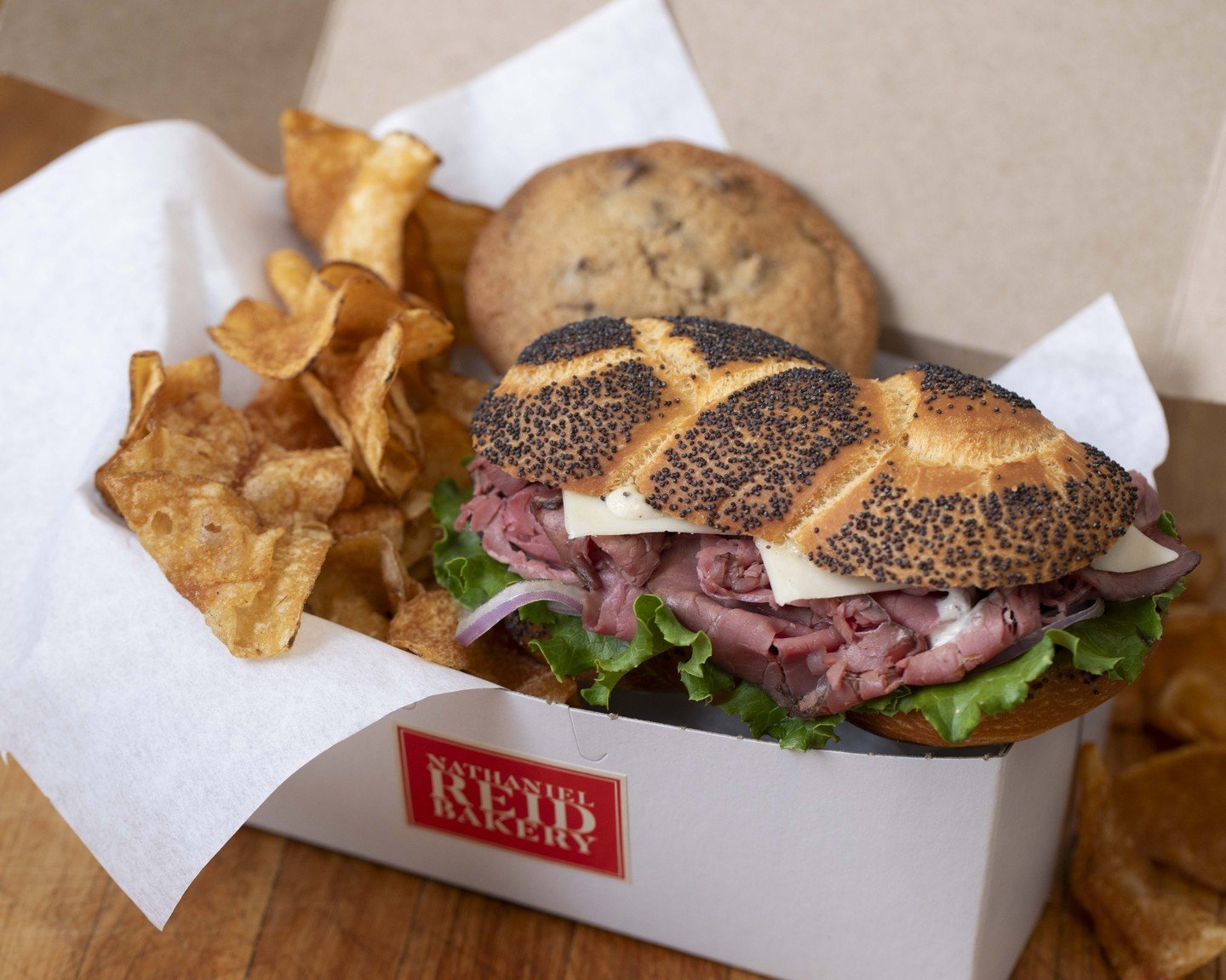 It's picnic season! Let us make your outdoor lunch extra special with our delicious boxed lunches. What better way to enjoy the beautiful weather than while savoring your favorite sandwich, freshly baked cookie, and crunchy locally made chips? Order 