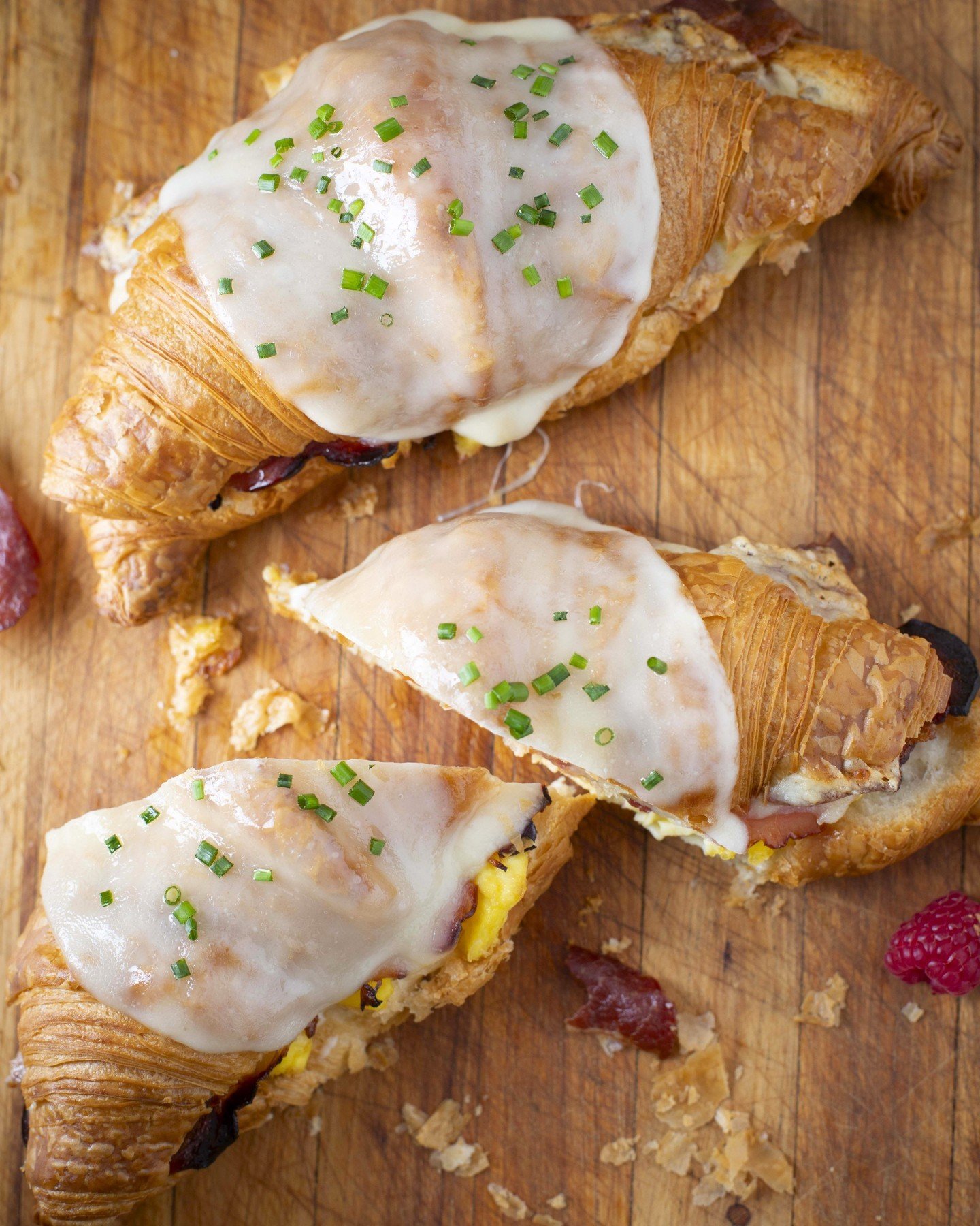 Rise and shine with our Saturday exclusive: the Croissant Breakfast Sandwich! Dive into layers of crispy bacon, savory ham, fluffy scrambled eggs, creamy b&eacute;chamel, and melted cheese, all nestled within our freshly baked croissant. The ultimate