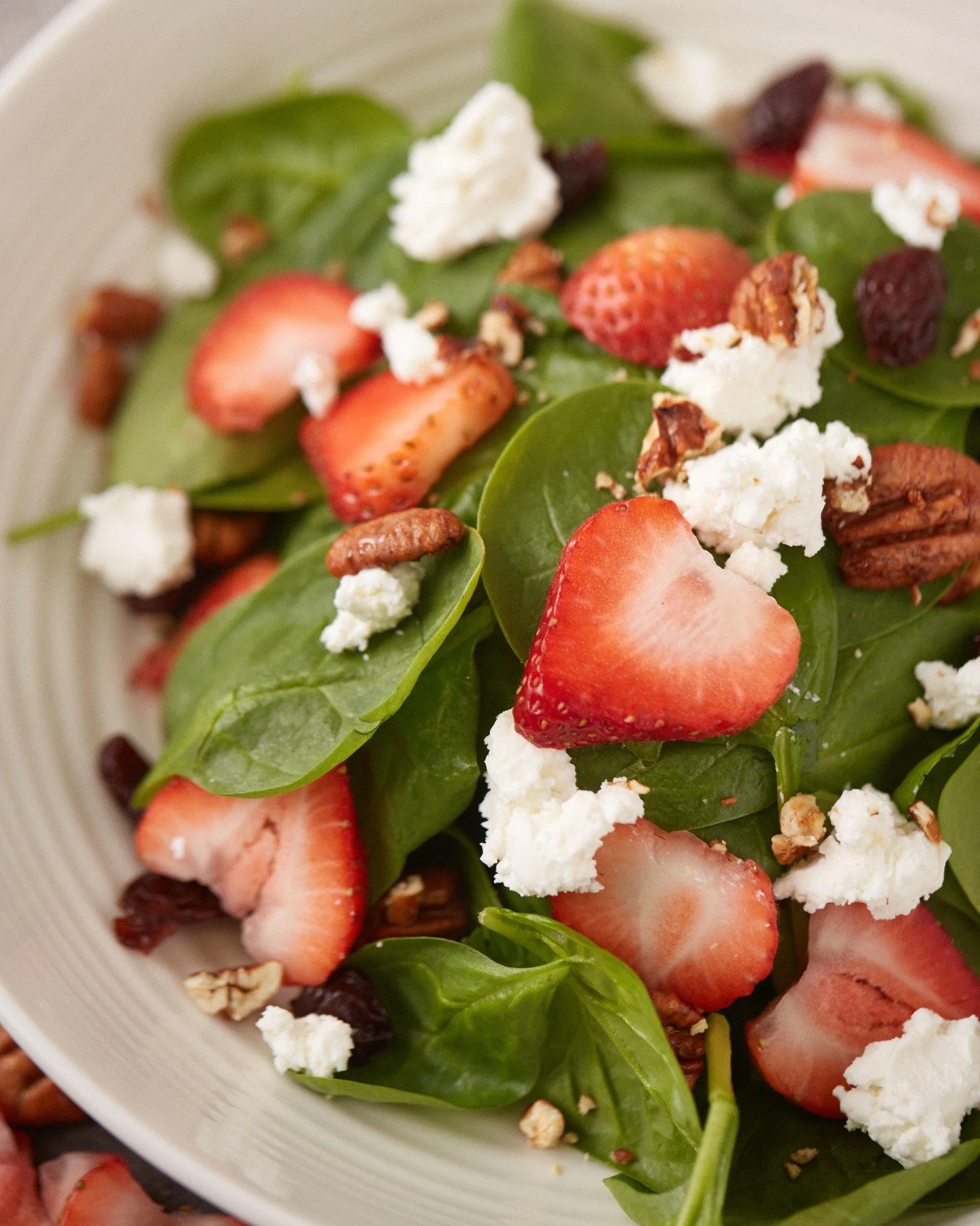 Our Orchard Salad pairs baby spinach with fresh strawberries, goat cheese, candied local pecans, and dried cherries, served with housemade strawberry balsamic vinaigrette. Perfect for a fresh lunch or light dinner!