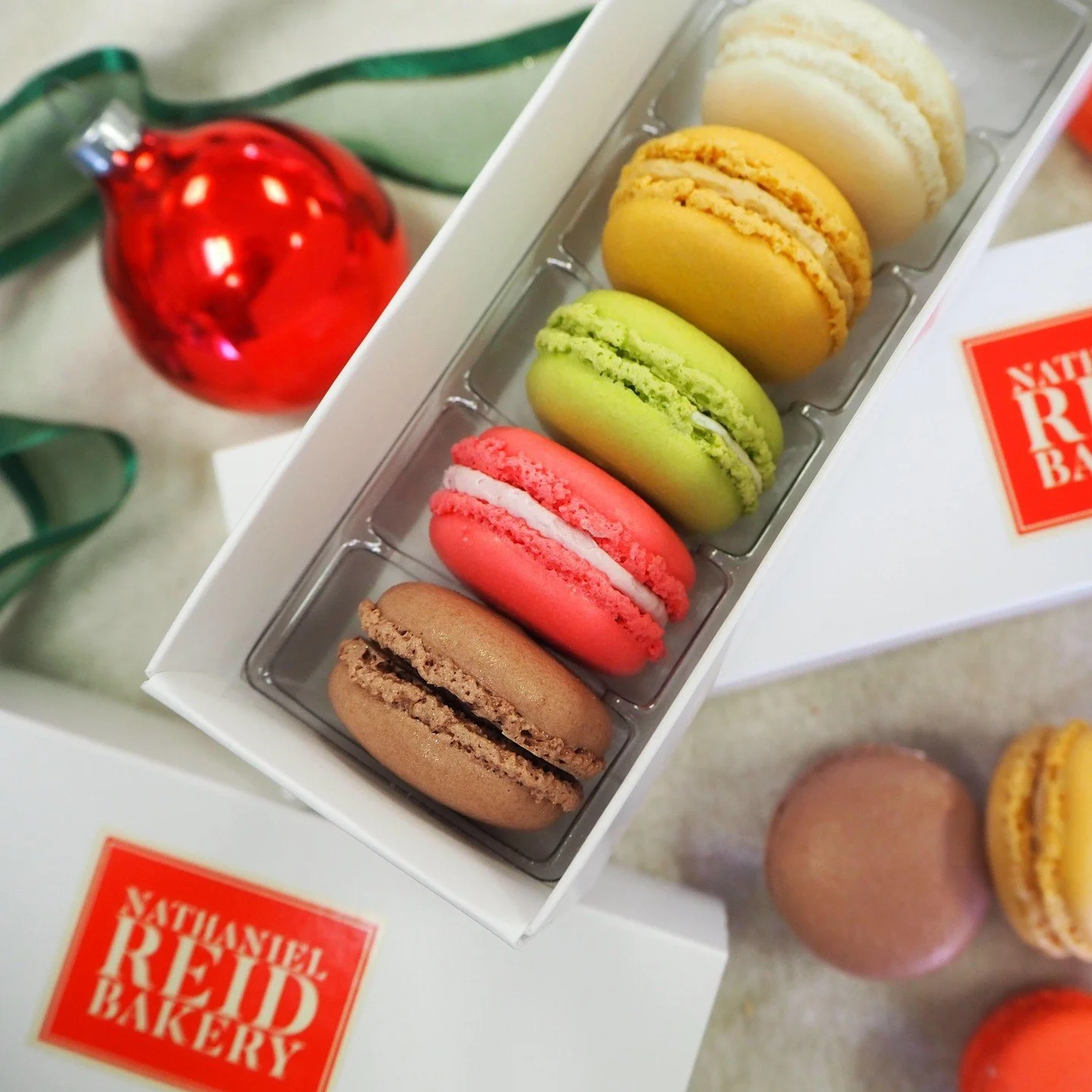 Our Holiday Macaron Boxes are the perfect gift for anyone on your list. Pre-order yours at nrbakery.com/winter-holidays, or visit us in-store-- our showcase is fully stocked with nine seasonal flavors, all made in-house.
