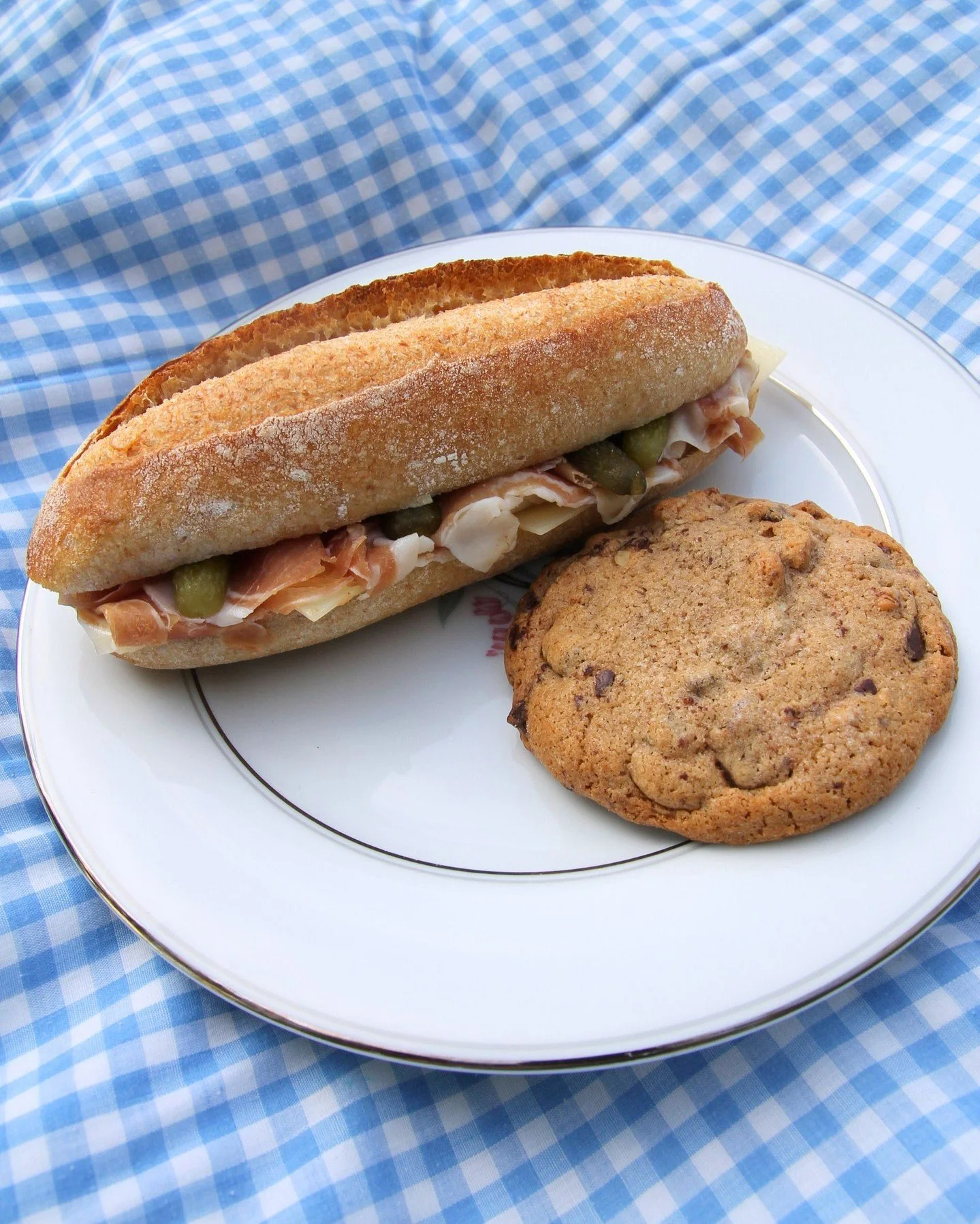 Our Prosciutto Sandwich layers local prosciutto with Gruy&egrave;re, cornichons, and Dijon aioli, tucked inside a buttered baguette. Pair it with your favorite cookie, grab a blanket, and lunch is covered.