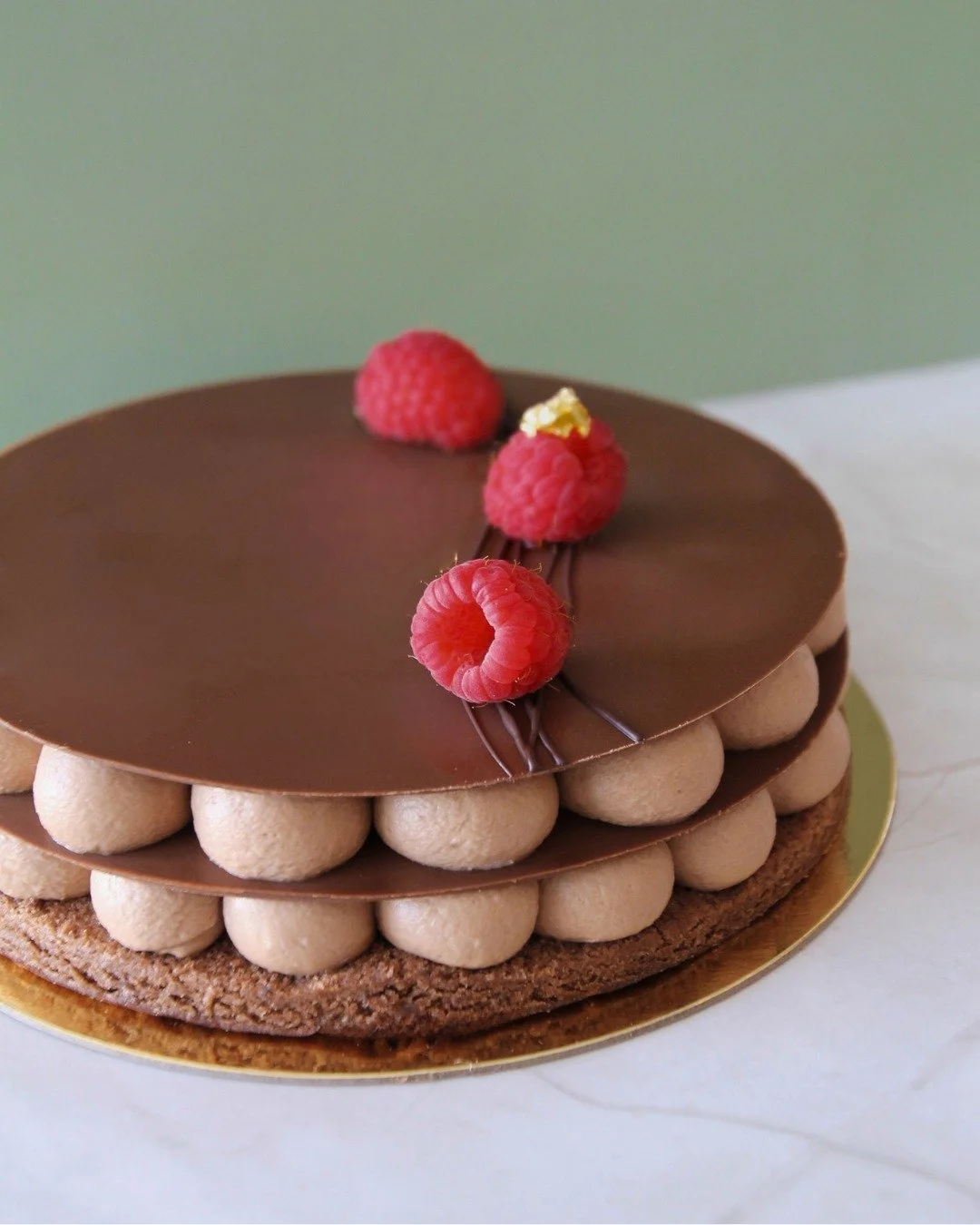 To kick off our 10-year anniversary celebration, the cake you voted for is back... the Enzo! 

Only a limited number of this chocolate almond cake with chocolate Chantilly, crispy hazelnut feuilletine, and raspberry caramel will be available in-store