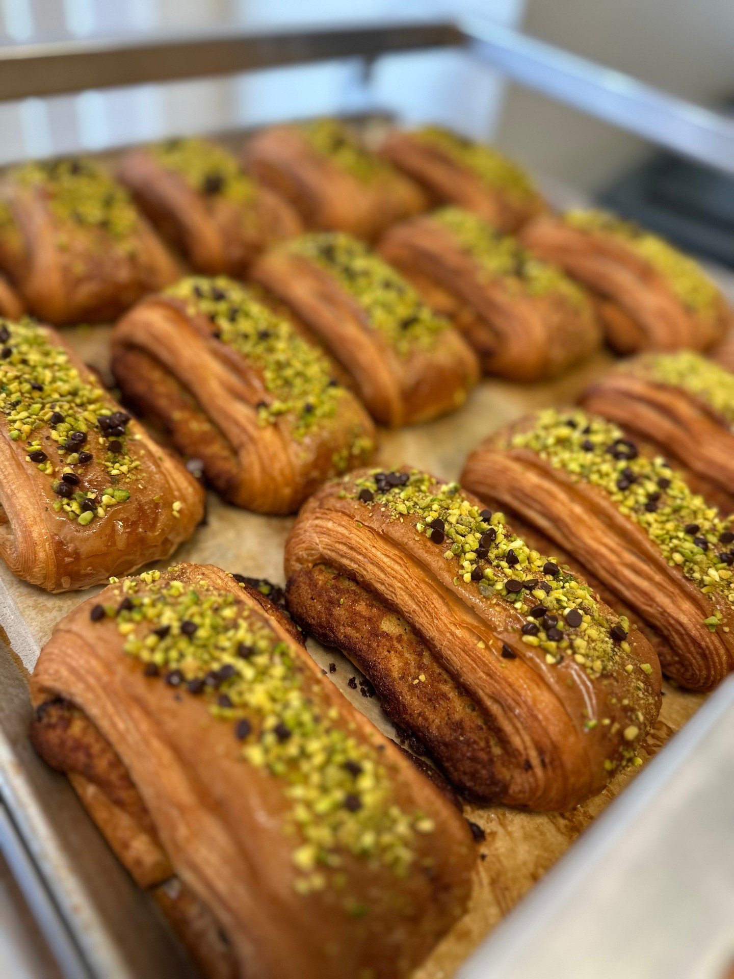 Back by popular demand, this month's seasonal Danish is the Dark Chocolate Pistachio! 💚

Buttery, flaky croissant is filled with sweet pistachio almond cream and dark chocolate, then baked until golden and finished with finely chopped pistachios and