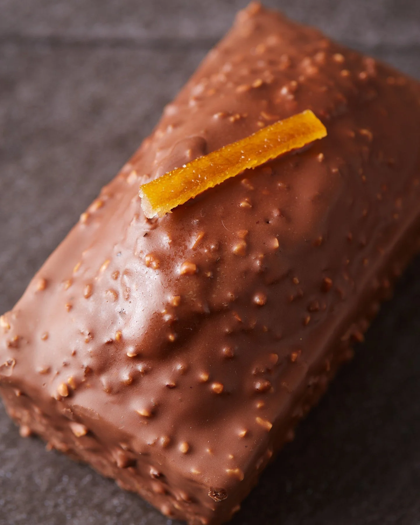 Get through the week with our Milk Chocolate Hazelnut Pound Cake! This moist hazelnut cake features bright orange and lemon zest and is coated in a textured milk chocolate with crunchy hazelnut praline. Perfect for desssert, or with your morning cup 