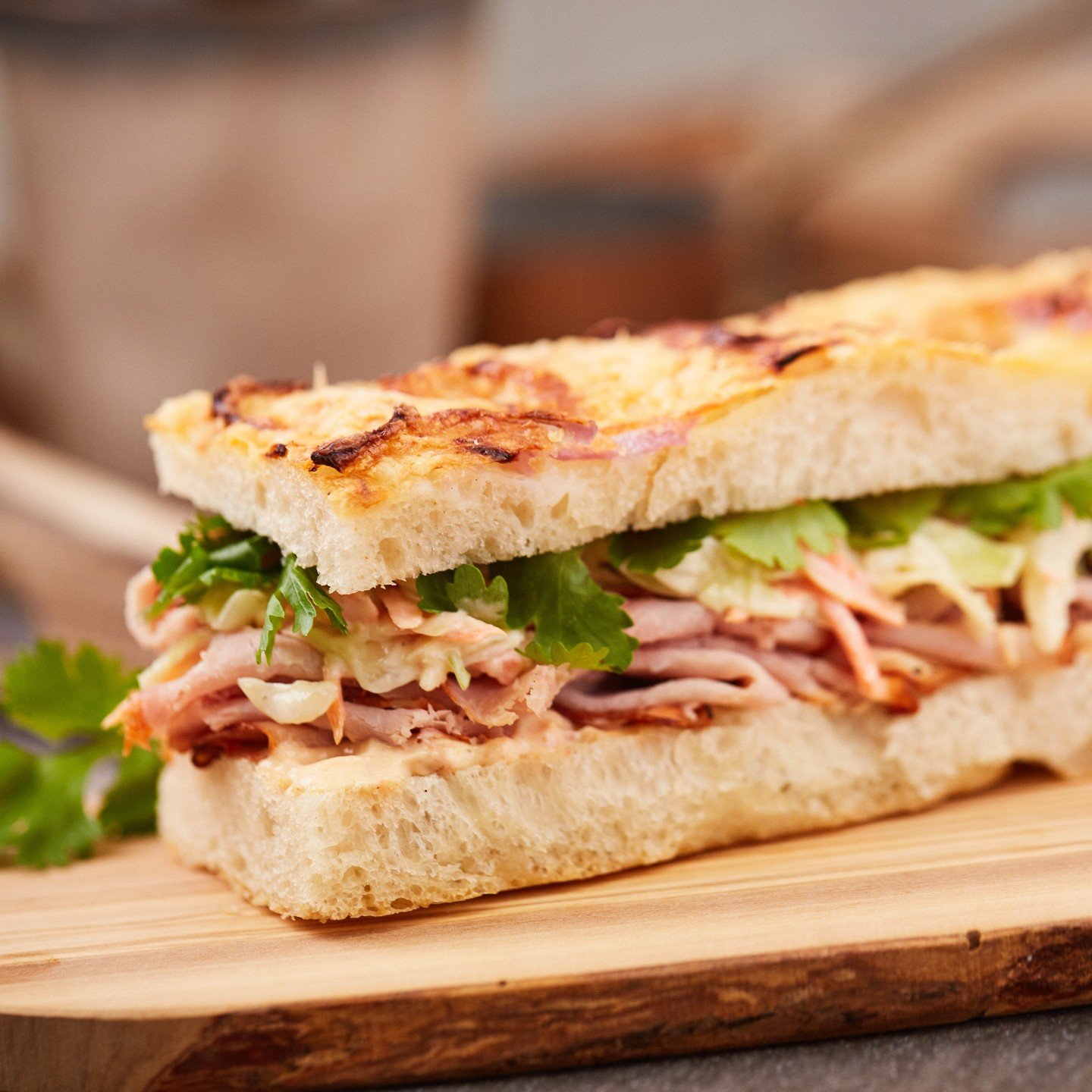 Tender smoked pork with crisp coleslaw, smokey chipotle aioli, and fresh cilantro on Parmesan red onion focaccia.

Stop by for lunch and make it the highlight of your day.
