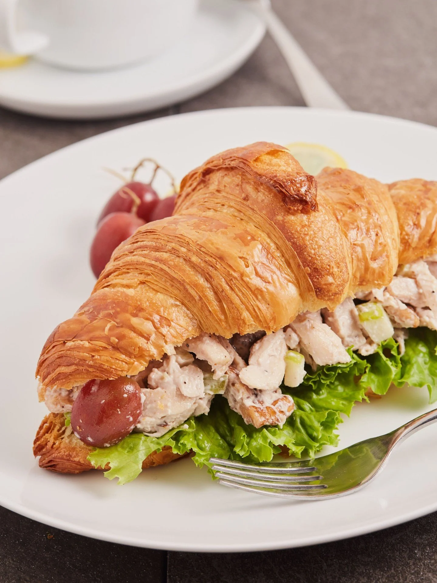 Roasted chicken breast, crisp Granny Smith apple, sweet red grapes, celery, and walnuts come together in our housemade Waldorf Chicken Salad.

Served with green leaf lettuce on our signature flaky croissant, it's a delicious favorite for any occasion