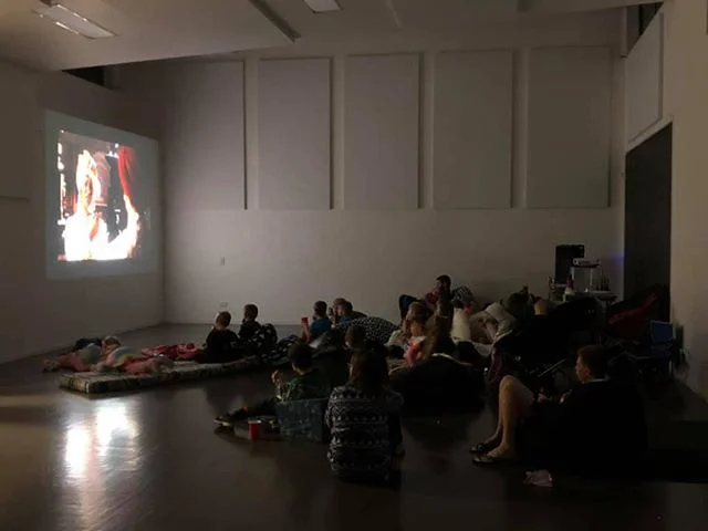 Kids and Adults watching a favourite movie