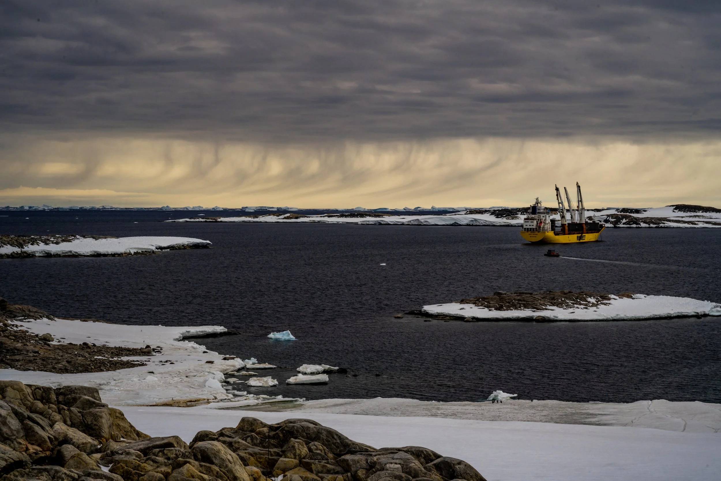 C48 - January 2022 - distant snow showers over Newcomb Bay with the Happy Dragon and continuing re-supply